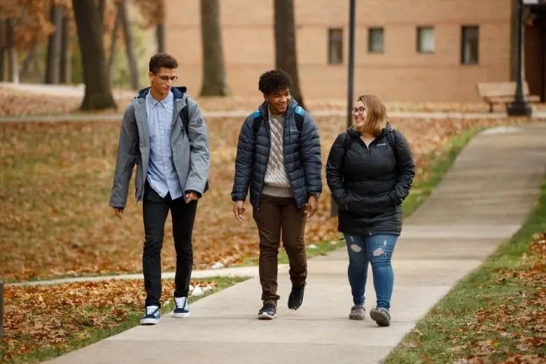 3 students walking outside