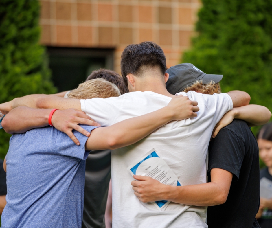 Students gathering and praying at Bethel University outside