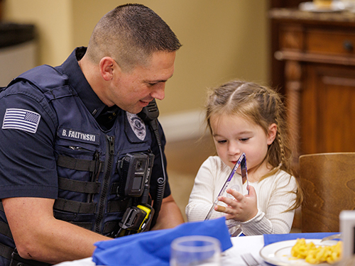 Bruce in police uniform with his daughter