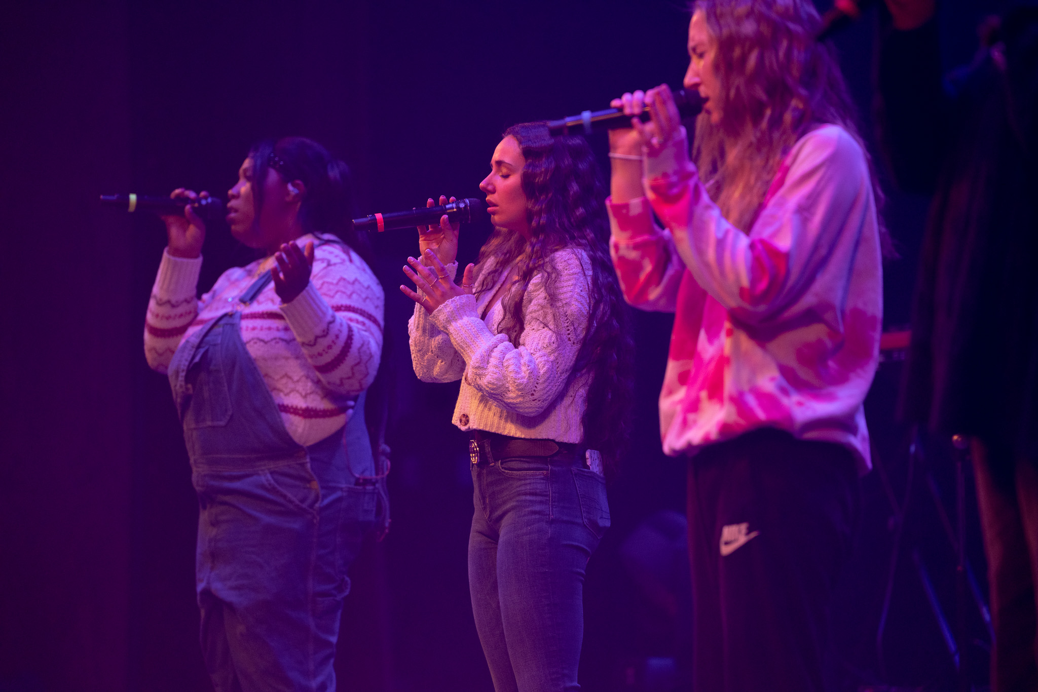 Bethel University Music Program with three students singing on stage