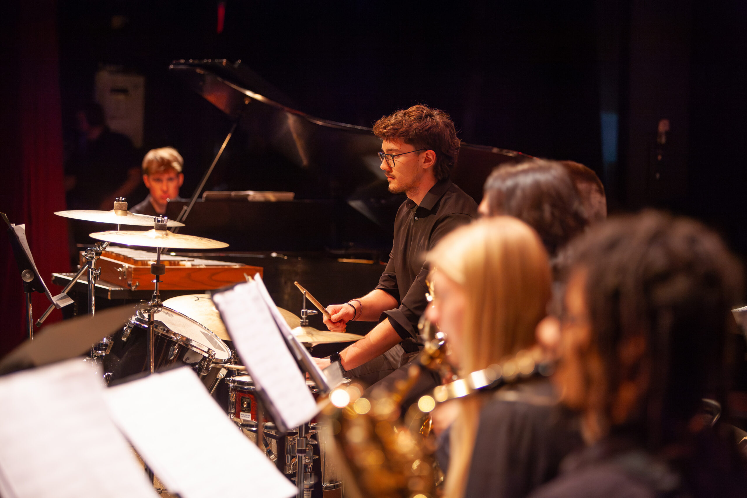 Bethel University Music Program with students playing the drums, piano and instruments at the Spring Instrumental Concerts
