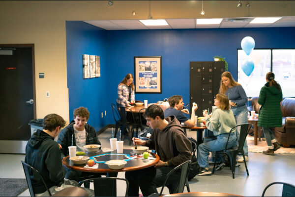 A photo of students gathering in Sufficient Grounds