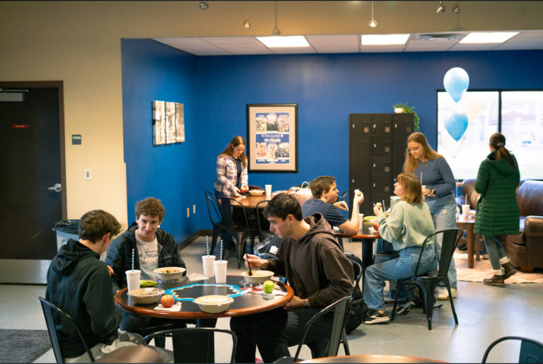 A photo of students gathering in Sufficient Grounds
