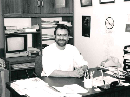 A young Norm Spivey sitting at his desk