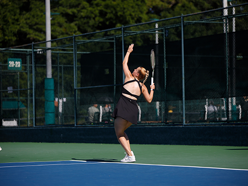 A woman serving a tennis ball