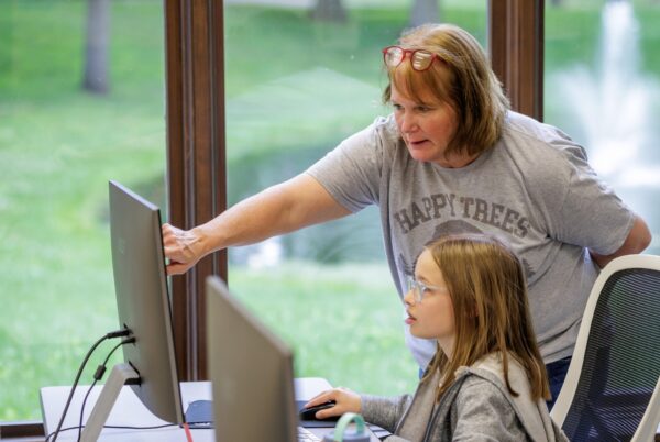 Instructor helping a student during Bethel University Pilot Summer Academy camp
