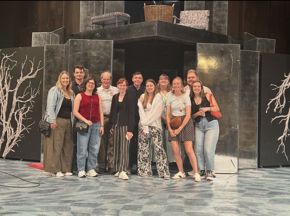 Bethel University students stand on the Festival Theatre stage in front of the set for "Dangerous Liaisons" during a theatre visit.