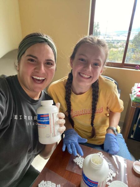 Two Bethel University Nursing Task Force students prepare medication for patients during a medical clinic in Ecuador.