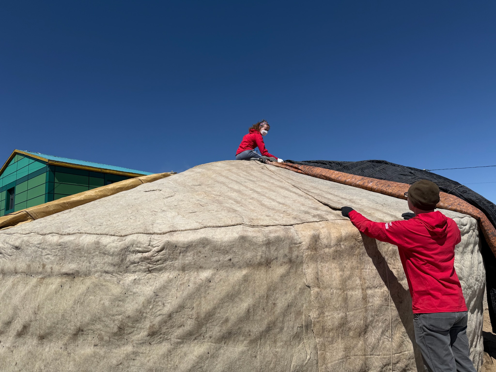 Bethel University Task Force students repair the roof covering of a traditional Mongolian ger during a community service project.