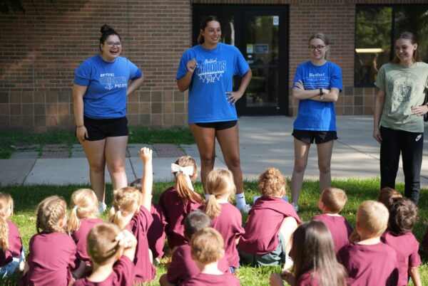Bethel University students lead a group of elementary students in an outdoor activity during the 2025 Baugo Promise “Walk Into My Future” event.
