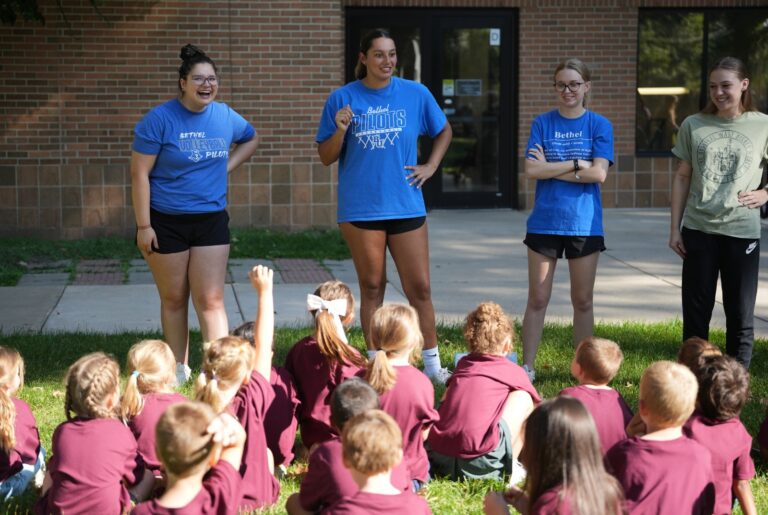 Bethel University students lead a group of elementary students in an outdoor activity during the 2025 Baugo Promise “Walk Into My Future” event.